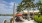 a beach with tables and umbrellas