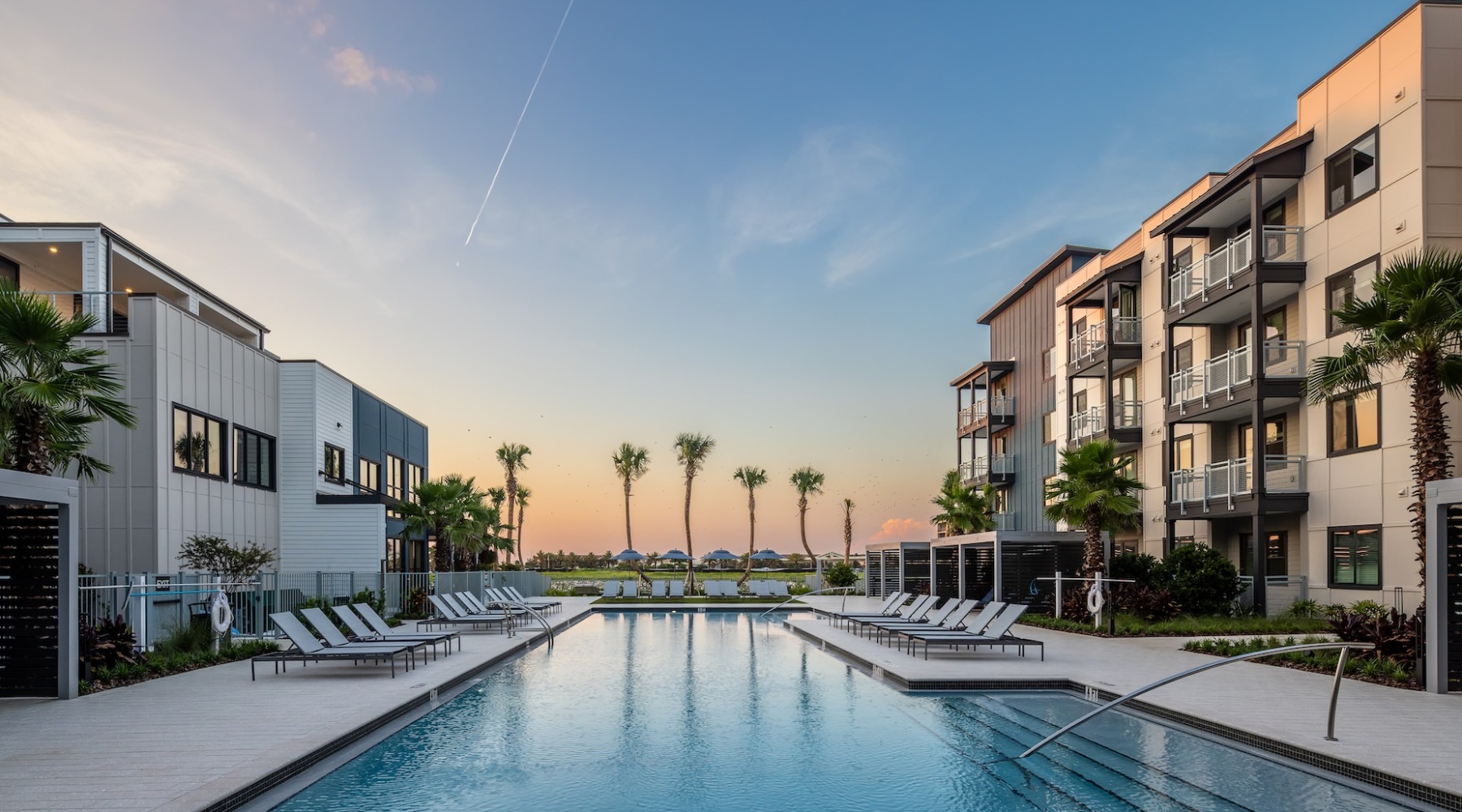 Dusk Shot of Heated saltwater pool with cabana seating