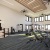 fitness center in a bright well-lit room showing plenty of equipment and modern decor in a large, spacious room