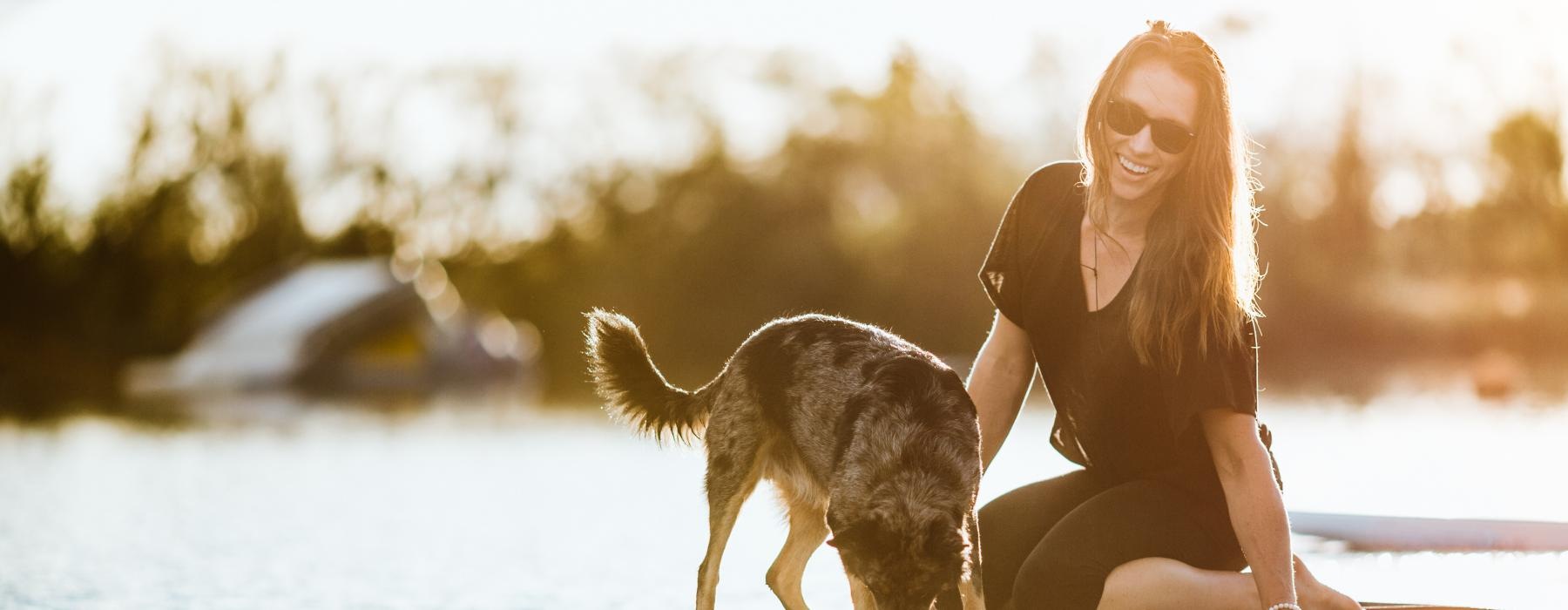 a person and a dog on a surfboard